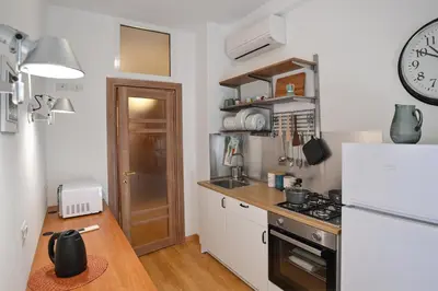 a small kitchen with a white refrigerator and a counter at Dodo House in Rome