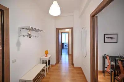 a white hallway with a table and a dining room at Dodo House in Rome