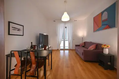 a living room with a table and a couch at Dodo House in Rome