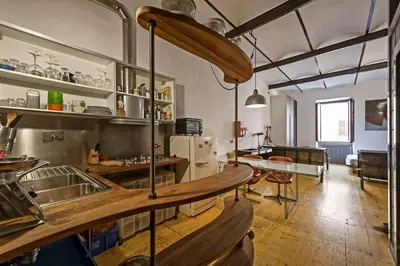 a kitchen with a sink and a table in a room at Design Loft a Roma in Rome
