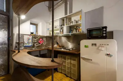 a kitchen with a sink and a refrigerator at Design Loft a Roma in Rome