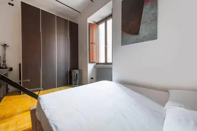 a bedroom with a large white bed in a room at Design Loft a Roma in Rome
