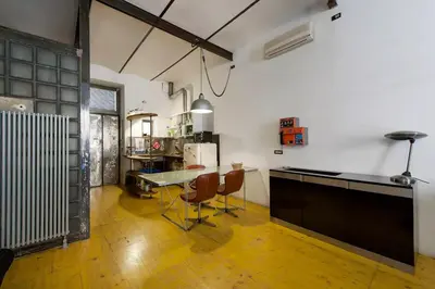 a kitchen with a table and chairs in a room at Design Loft a Roma in Rome