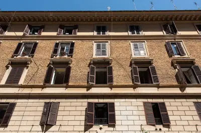 a tall brick building with many windows on it at Vatican Scipioni Apartment in Rome