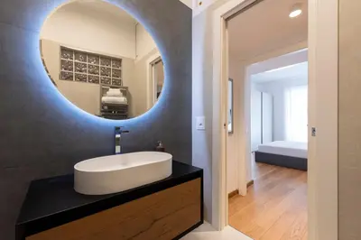 a bathroom with a sink and a mirror at Vatican Scipioni Apartment in Rome