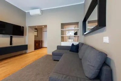 a living room with a couch and a flat screen tv at Vatican Scipioni Apartment in Rome