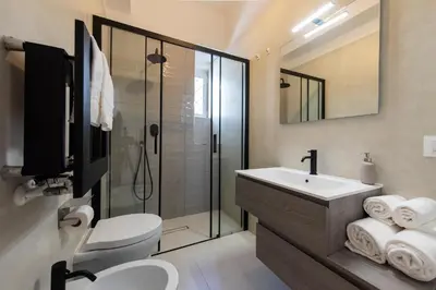 a bathroom with a toilet and a sink and a shower at Vatican Scipioni Apartment in Rome