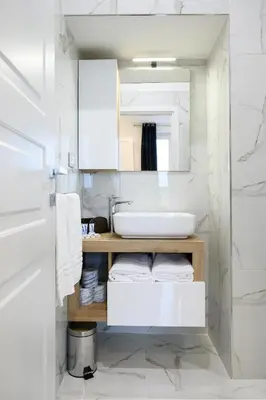 a white bathroom with a sink and a mirror at Domus Ludovica in Rome