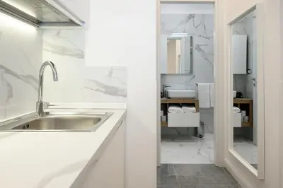 a white bathroom with a sink and a toilet at Domus Ludovica in Rome