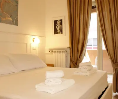 a bedroom with a bed with towels on it at Mama House 2 - Trastevere in Rome