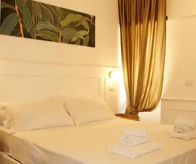 a bedroom with a white bed with towels on it at Mama House 2 - Trastevere in Rome