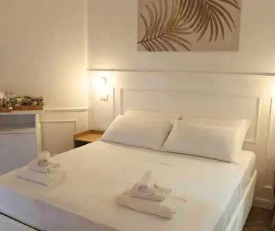 a bedroom with a white bed with towels on it at Mama House 2 - Trastevere in Rome