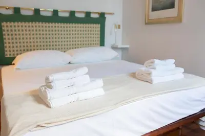 a pile of towels sitting on top of a bed at Suite Bormida - Coppedè in Rome