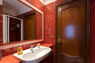 a bathroom with a sink and a mirror at Suite Bormida - Coppedè in Rome