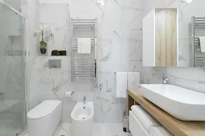 a white bathroom with a sink and a toilet at Domus Enrico in Rome