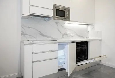 a kitchen with a white counter top with a microwave at Domus Enrico in Rome