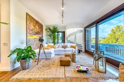 a living room filled with furniture and a large window at Skylife Art Gallery Loft - Riverfront Art Sanctuary in Rome