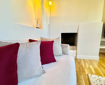 a living room with a couch with red and white pillows at Vetrina Roma - Stay in Luxury in Rome