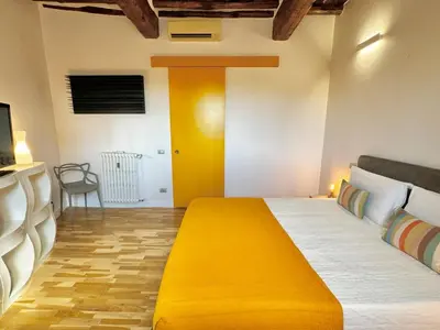 a bedroom with a yellow bed in a room at Vetrina Roma - Stay in Luxury in Rome