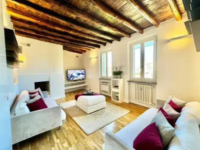 a living room with two couches and a tv at Vetrina Roma - Stay in Luxury in Rome