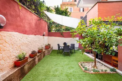 a courtyard with a table and chairs and plants at Aurea Suite Vaticano in Rome