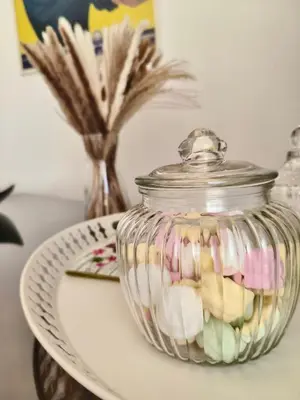 a glass jar filled with marshmallows on top of a plate at Casa Ines in Rome