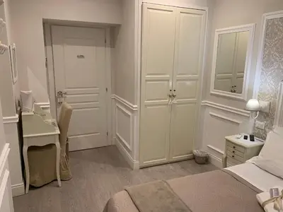 a bedroom with a bed and a desk and a mirror at Charme & Chic Prestige in Rome