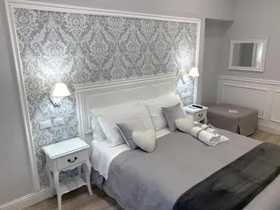 a bedroom with a white bed with pillows at Charme & Chic Prestige in Rome