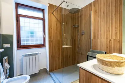 a bathroom with a shower and a toilet and a sink at Olive Whisper Rome Garden and Sauna in Rome