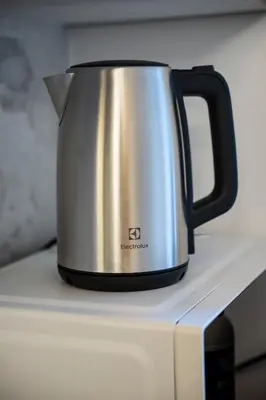 a tea kettle sitting on top of a stove at Olive Whisper Rome Garden and Sauna in Rome