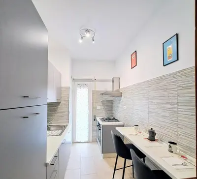 a kitchen with a counter and a stove top oven at Cozy apartment near metro A in Rome