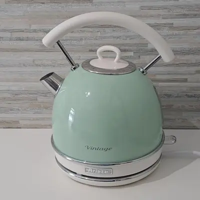 a green tea kettle sitting on top of a counter at Cozy apartment near metro A in Rome