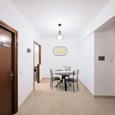 a dining room with a table and chairs at Cozy apartment near metro A in Rome