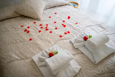 a bed with white towels with red hearts on it at Affittacamere Tiche in Rome