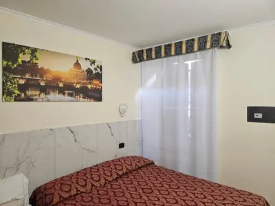 a bedroom with a bed and a window at Affittacamere Tiche in Rome