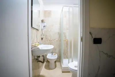 a bathroom with a sink and a toilet and a shower at Affittacamere Tiche in Rome