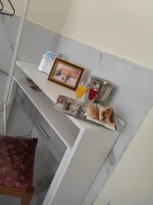 a shelf with some pastries and drinks on it at Affittacamere Tiche in Rome