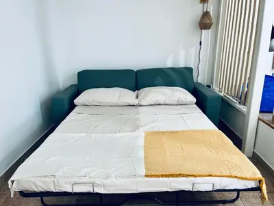 a bed in a room with a blue head board at Leonardo Guest House Roma in Rome