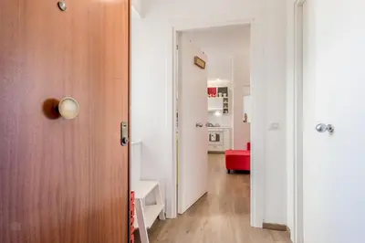 a hallway with a door and a living room at True Colors Vatican Home in Rome