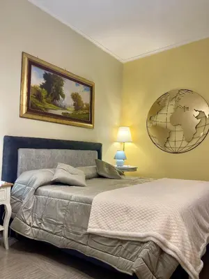 a bedroom with a large bed and a globe on the wall at Barbi's Home- Colli Albani Roma in Rome