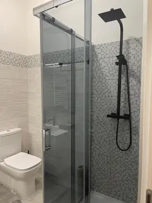 a bathroom with a glass shower with a toilet at Barbi's Home- Colli Albani Roma in Rome