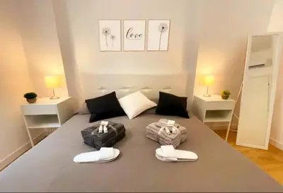 a room with a bed with two slippers on it at Sky Hub21 in Rome