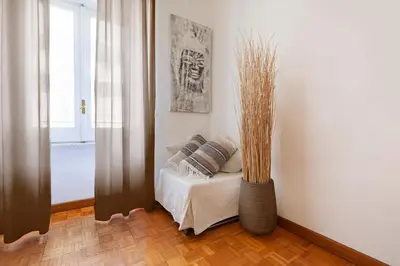 a room with a couch with pillows and a vase at Spanish Steps Historic Apartment in Rome