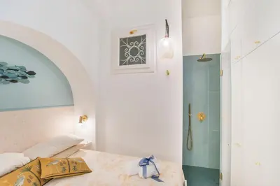 a bedroom with a bed and a shower at 15 minutes to Colosseum - Loft with terrace in Rome