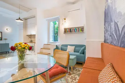 a living room with a glass table and a couch at 15 minutes to Colosseum - Loft with terrace in Rome