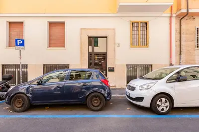two cars parked next to each other in a parking lot at Dimora Testaccio in Rome