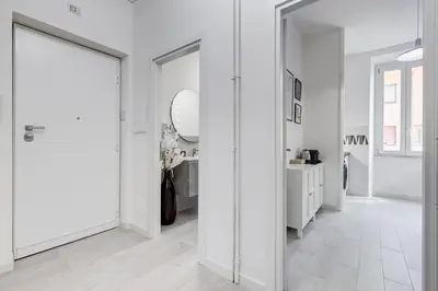 a hallway with white walls and a mirror at Dimora Testaccio in Rome
