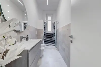 a bathroom with a sink and a toilet and a shower at Dimora Testaccio in Rome
