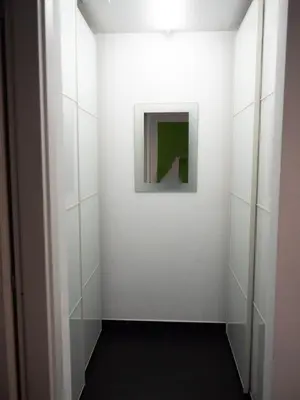 a hallway with white walls and a painting on the wall at Conca D'oro Colors - Metro & WI-FI in Rome