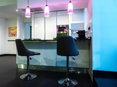 a kitchen with two chairs in front of a counter at Conca D'oro Colors - Metro & WI-FI in Rome